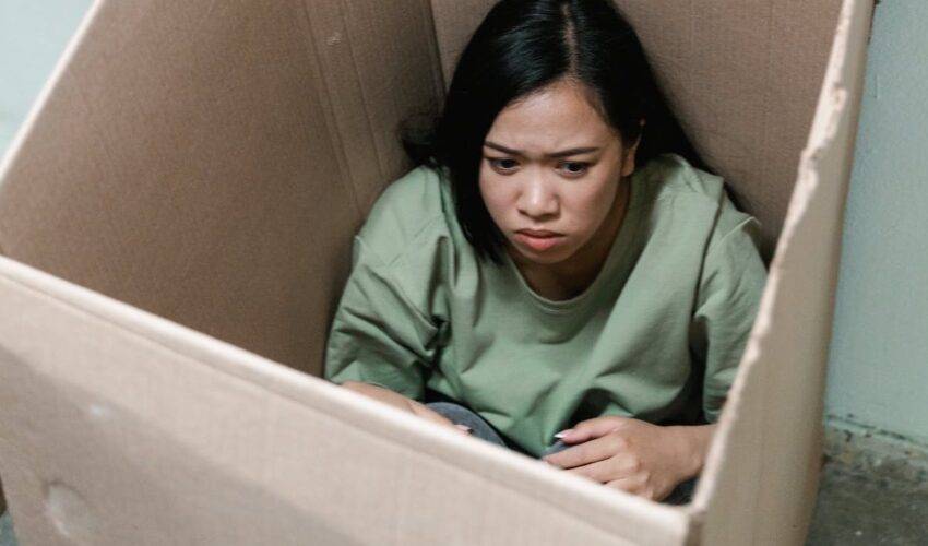 femme qui se cache dans un carton