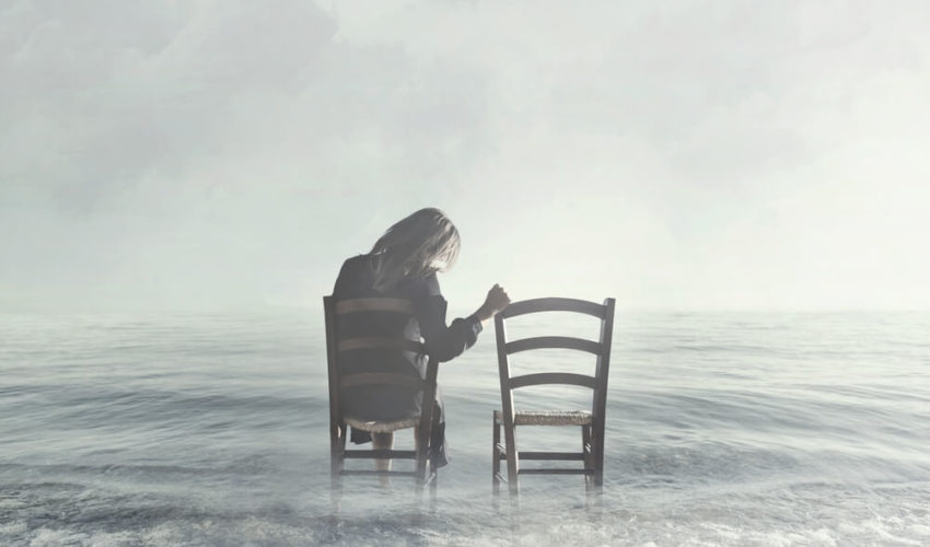 femme assise sur une chaise dans l'eau